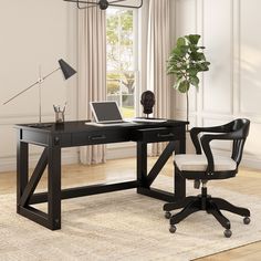 a black desk with a laptop on it and a chair next to it in front of a window