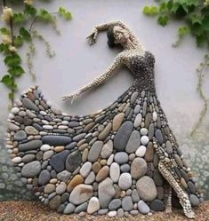 a woman in a dress made out of rocks