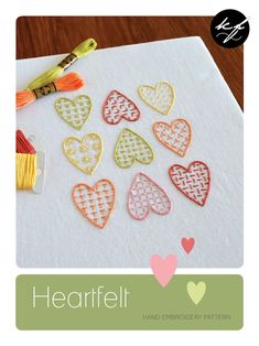 heart - shaped cutouts are sitting on top of a piece of paper with yarn