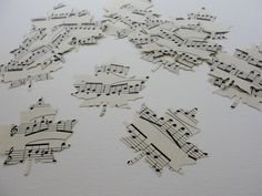 many pieces of paper with musical notes cut out of them and placed on top of each other