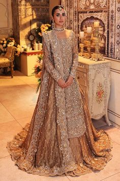 a woman in a wedding dress standing next to a table