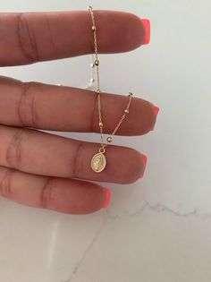 14K Yellow Gold Dainty Solid Gold Miraculous Virgin Mary, Tiny Virgin Medal Necklace, Religious Jewelry For Women, Virgin Mary Necklace  ⁙ Materials: 14K Solid Gold ⁙ Available Colors: Yellow Gold ⁙ Necklace Measurements: Necklace is 16" in length, please measure your neck prior to orderings. the Miraculous Medal is 10MM in height by 6MM wide, beads are 2MM wide MATERIALS All chains are made of 14K Solid Gold  HOW TO FIND YOUR PERFECT FIT Your neck size is the most important measurement for determining which necklace length will work best for you. To measure, wrap a soft tape measure around your neck, keeping the tape measure parallel to the floor as you measure. Then, add 2 to 4 inches (5 to 10 cm) to your neck measurement to calculate your desired/minimum recommended chain length. We are Necklace Measurements, Mary Necklace, Virgin Mary Necklace, Yellow Gold Necklace, Pompano Beach, Miraculous Medal, Religious Jewelry, Tape Measure, Virgin Mary