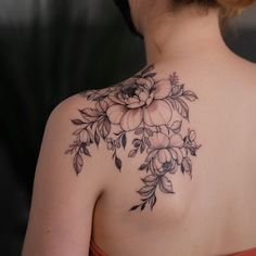 a woman with a flower tattoo on her shoulder