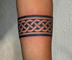 a man's arm with a tattoo on it that looks like a celtic knot