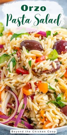 pasta salad with olives, peppers and onions in a white bowl