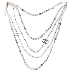 Chanel​ ​CC​ ​long​ ​necklace​ ​in​ ​white​ ​pearly​ ​pearls​ ​and​ ​gold​ ​metal​ ​with​ ​blue​ ​inscriptions​ ​in​ ​5​ ​rows Length:​ ​37cm Reference:​ ​101449 General​ ​condition:​ ​7.5/10 Sold​ ​with​ ​box Pearl Gold Necklace, Chanel Pearl, Necklace With Pearl, Chanel Necklace, Chanel Pearls, Crystal Chandelier Earrings, Beaded Tassel Earrings, Gold Pearl Necklace, Chanel Jewelry