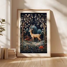 a framed art print of a deer in a forest surrounded by flowers and trees, on a wooden floor