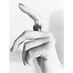 a black and white photo of a person's hand with a banana on it