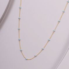 This meticulously crafted necklace is made with 14-karat gold and adorned with gentle, blue enamel accents. A sublime addition to any outfit, it brings a perfect touch of color and sophistication to your ensemble. Elegant Blue Delicate Chain Necklace, Elegant Blue Beaded Chain Necklace, Light Blue Sterling Silver Necklace Fine Jewelry, Dainty Blue Chain Necklace With Adjustable Chain, Light Blue Sterling Silver Necklace, Elegant Light Blue Necklace With Beaded Chain, Fine Jewelry In 14k Gold With Light Blue Color, Light Blue 14k Gold Fine Jewelry, Elegant Blue Necklace With Cable Chain