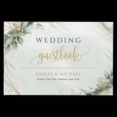 a wedding guest book with greenery and gold lettering