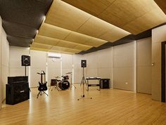 an empty room with guitars and amps on the floor