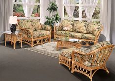 a living room with wicker furniture and curtains on the window sill, in front of a white drapes