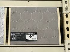 there is a price label on the back of a metal rack with hexagonal tiles