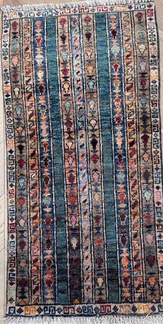 an old rug with multicolored stripes and fringes