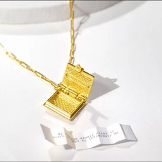 If you love reading, then our Book Locket Necklace is a must-have accessory for you! This stylish necklace features a miniature book locket that opens to reveal a hidden message, quote, or poem. It's the perfect way to keep your love of reading close to your heart, and it makes a great gift for any bookworm in your life. The magenta enamel detailing is a nod to a next chapter full of compassion, emotional balance and harmony. Material:gold-dipped brass.Book Locket Dimensions: 15mm (0.6"") (w) x Book Locket Necklace, Book Dimensions, Valentine's Ideas, Secret Diary, Book Locket, Miniature Book, Locket Bracelet, Diary Book, Personal Narrative