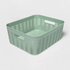 a green plastic basket with handles