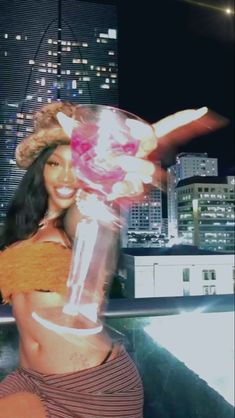 a woman is posing in front of a city skyline