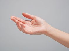 a person's hand reaching out towards the sky with their left arm stretched out