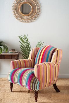 a colorful striped chair sitting in front of a mirror