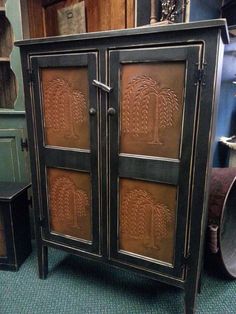 an antique cabinet with carved designs on the doors and drawers is displayed in a shop