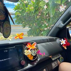 flowers are placed on the dashboard of a car