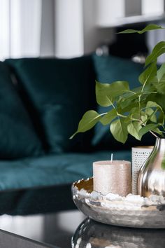 a living room with a couch, coffee table and candles