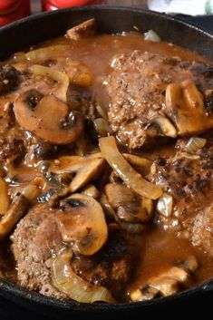 a skillet filled with meat, mushrooms and gravy in a sauce that says salisbury steak skillet