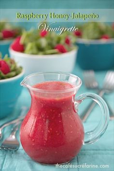 raspberry honey jalapeno in a pitcher next to bowls of salad