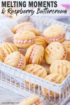 a basket filled with pink frosted cookies on top of a table