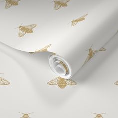 a white and gold wallpaper with bees on it