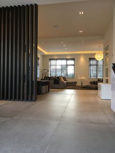 an empty living room with black and white decor