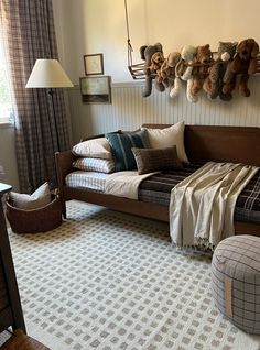 a living room filled with furniture and stuffed animals on the wall above it's bed