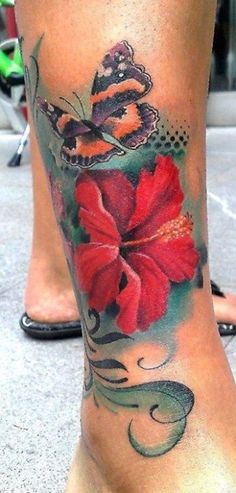 a woman's foot with a flower tattoo on her left side and the bottom part of her leg