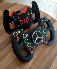 the steering wheel and pedals are all made out of black plastic with colorful buttons