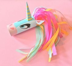 a paper roll with a unicorn's head on it and streamers around it