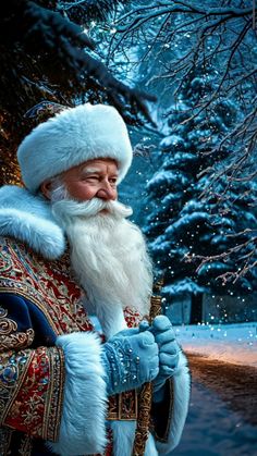 a man dressed as santa claus standing in front of a snowy tree with snowflakes on it