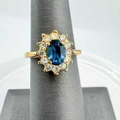 a ring with a blue stone surrounded by white and yellow diamonds on a napkin holder