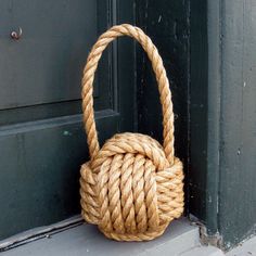 a rope bag hanging on the side of a door with it's handle down