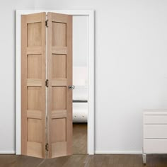 an open wooden door in a white room