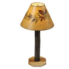 a lamp that is sitting on top of a wooden stand with a bird painted on it