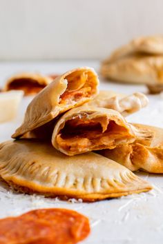 several pastries are stacked on top of each other and ready to be eaten with sauces