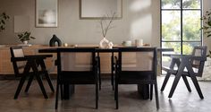 a dining room table with chairs and vases on top of it in front of a large window