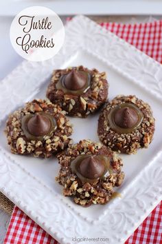 chocolate covered cookies are on a white plate