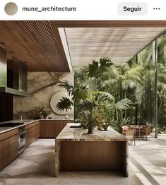 an image of a kitchen with plants on the counter and in the background are trees