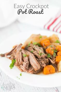 an easy crockpot pot roast with carrots and potatoes on a white plate