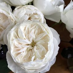 a bunch of white flowers sitting on top of a table