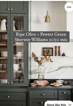 a kitchen with green cabinets and white marble counter tops, along with the words ripe olive + pewter green sherwin williams $ 50 / 50 / 50 mix