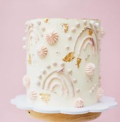 a close up of a cake on a plate with pink and gold decorations around it