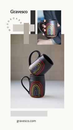 two coffee mugs are stacked on top of each other, one has a rainbow design