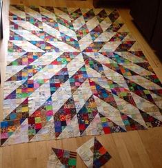 a patchwork quilt is laying on the floor